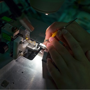 Close up image of person working at microscope